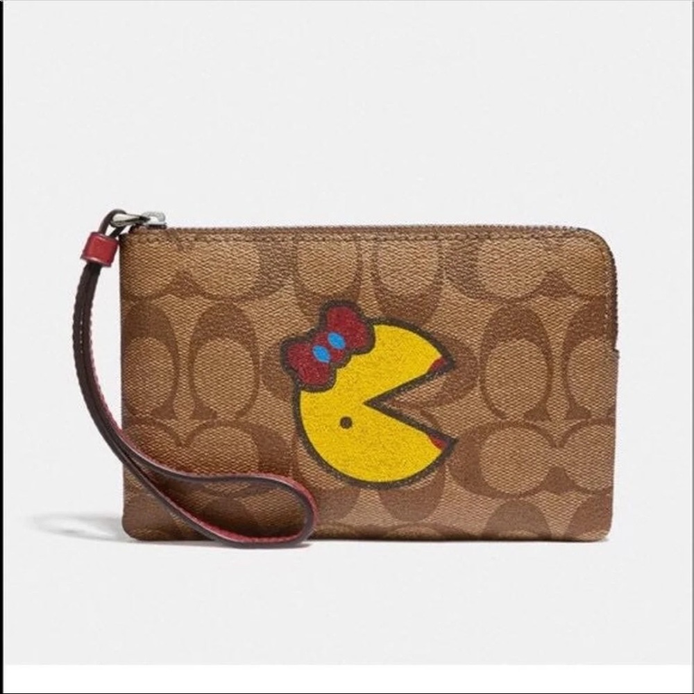 Coach Graphic Ms. Pac-Man Corner Zip Wristlet In Signature Print.